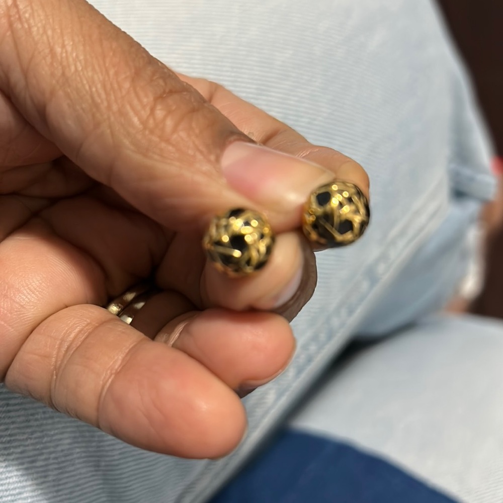 Gold and black earrings.